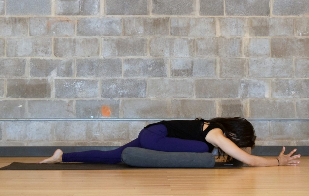 Yoga poses for low back pain relief - supported pigeon pose with bolster - eka pada raja kapotasana - Argentina Rosado Yoga New York