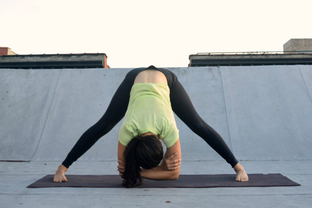 5 yoga poses for tight hamstrings - prasarita padattonasana - Argentina Rosado Yoga New York